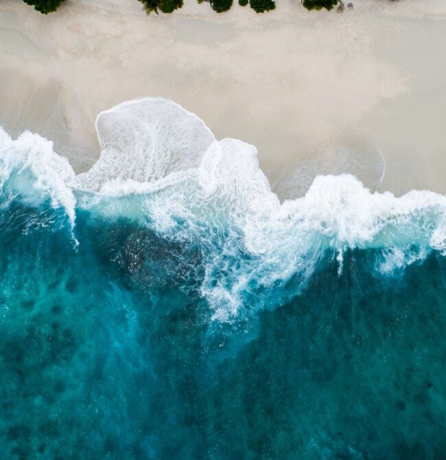 aerial shot of wave meeting the beach